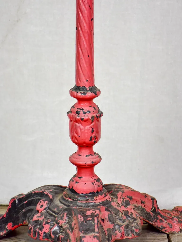 Late nineteenth century French bistro table with red cast iron base