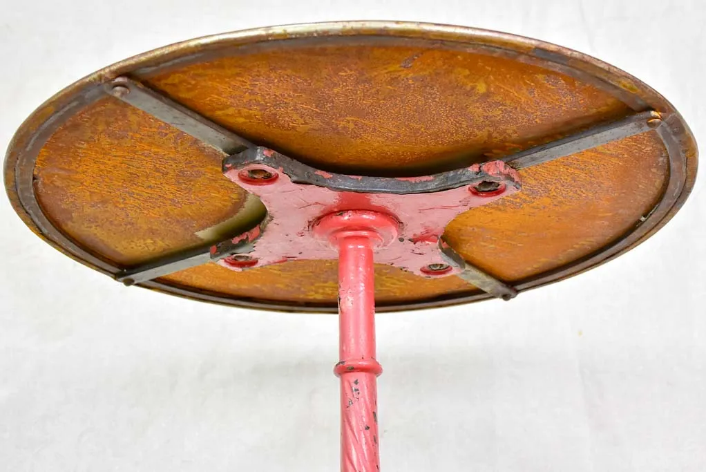 Late nineteenth century French bistro table with red cast iron base