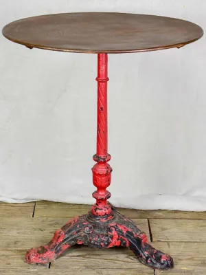 Late nineteenth century French bistro table with red cast iron base