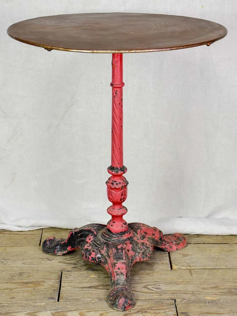 Late nineteenth century French bistro table with red cast iron base